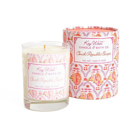 Candle with decorative label and matching container on a white background