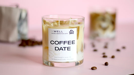 Candle labeled 'Coffee Date' with coffee beans on a pink background