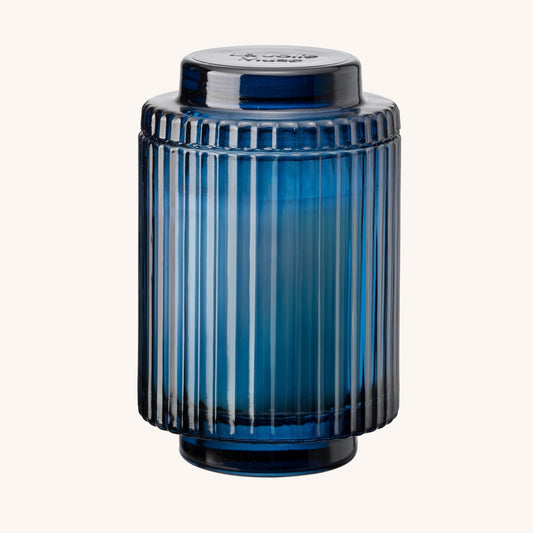 Blue ribbed vase on a white background