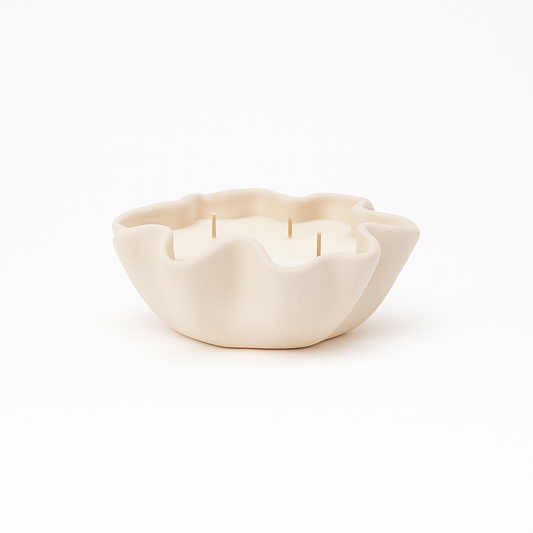 White ceramic bowl with a candle inside on a white background