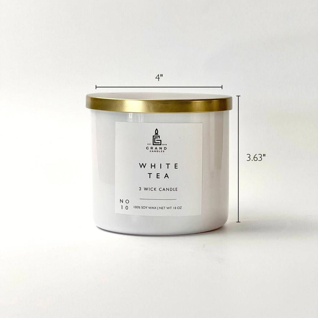White tea candle with gold lid and dimensions on a white background